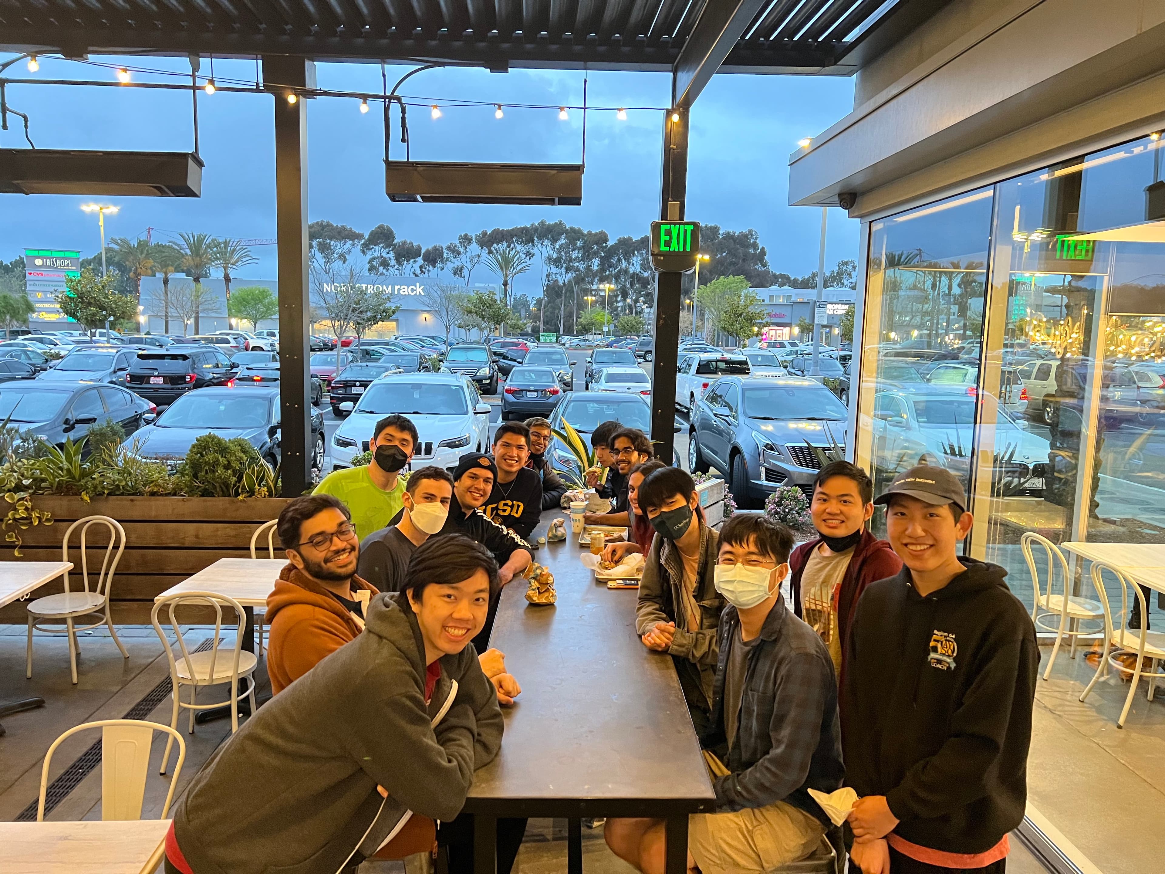 members sitting at a table smiling