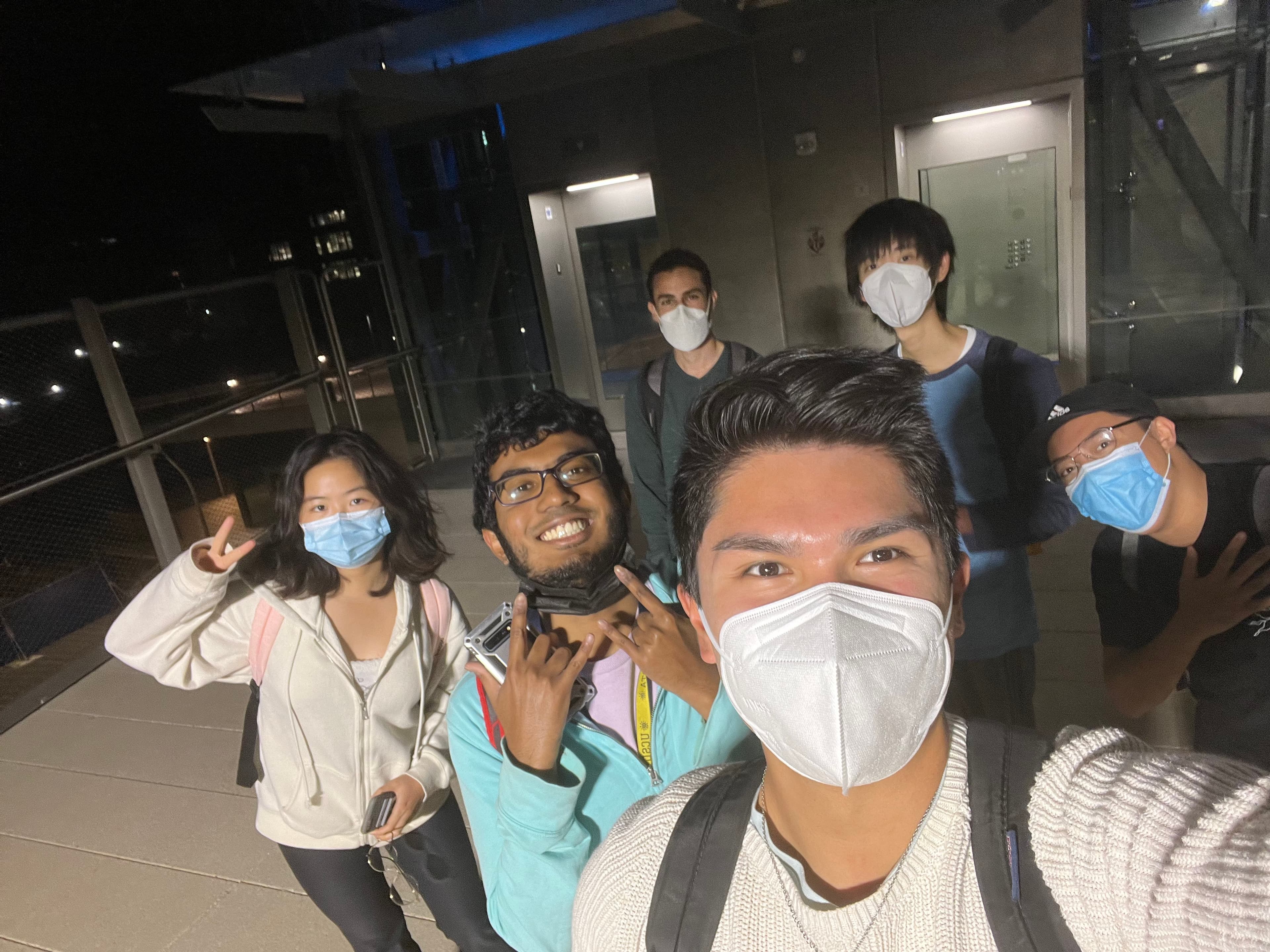 people masked outside the elevators at Nobel Drive Station