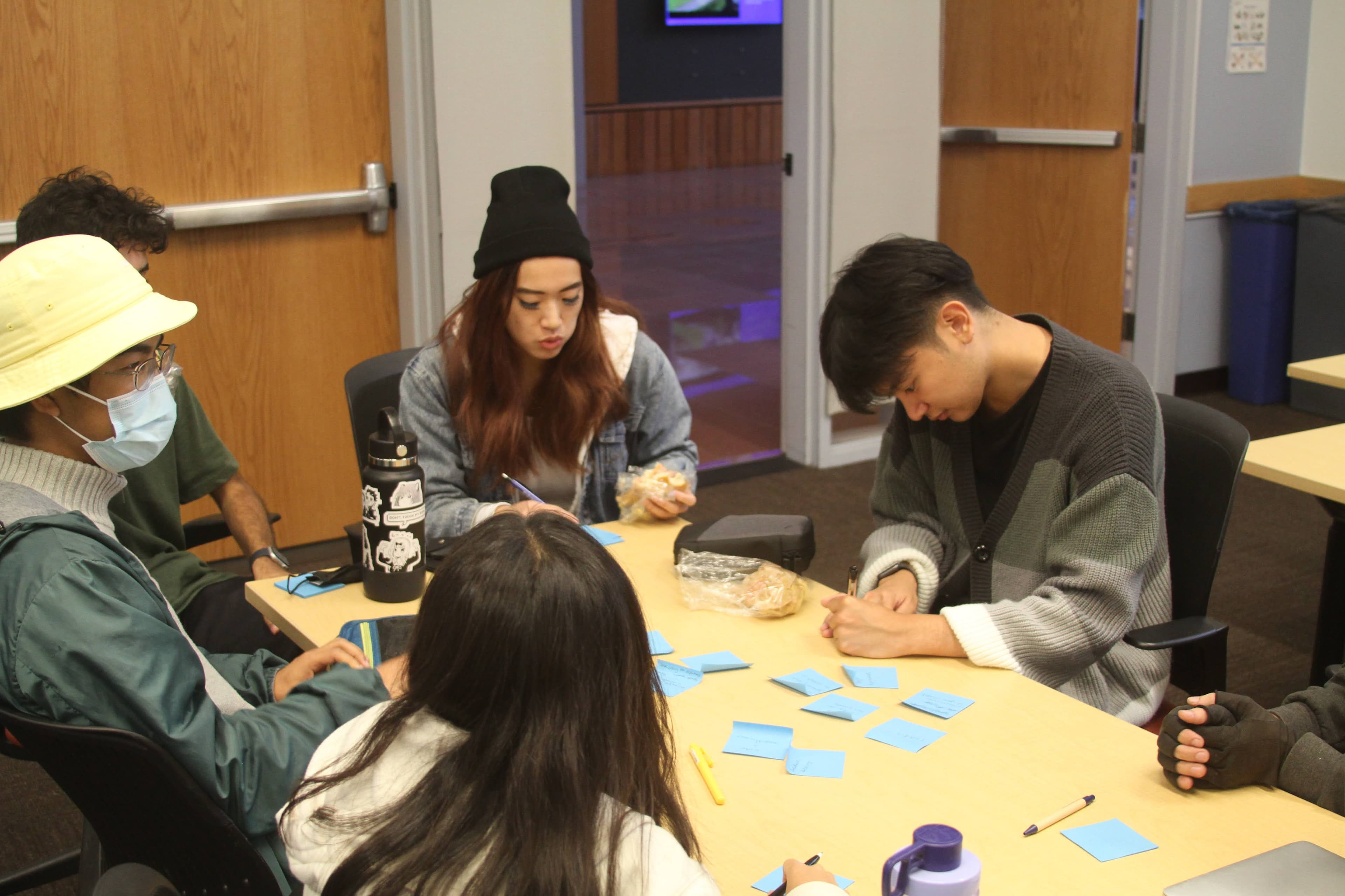 People brainstorming designs on sticky notes